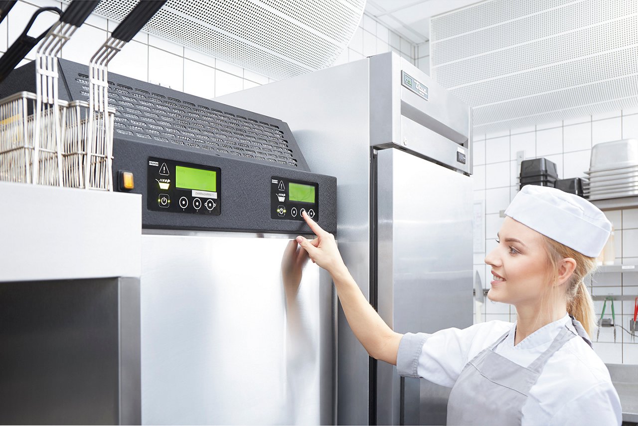 Female worker operates dispenser control panel